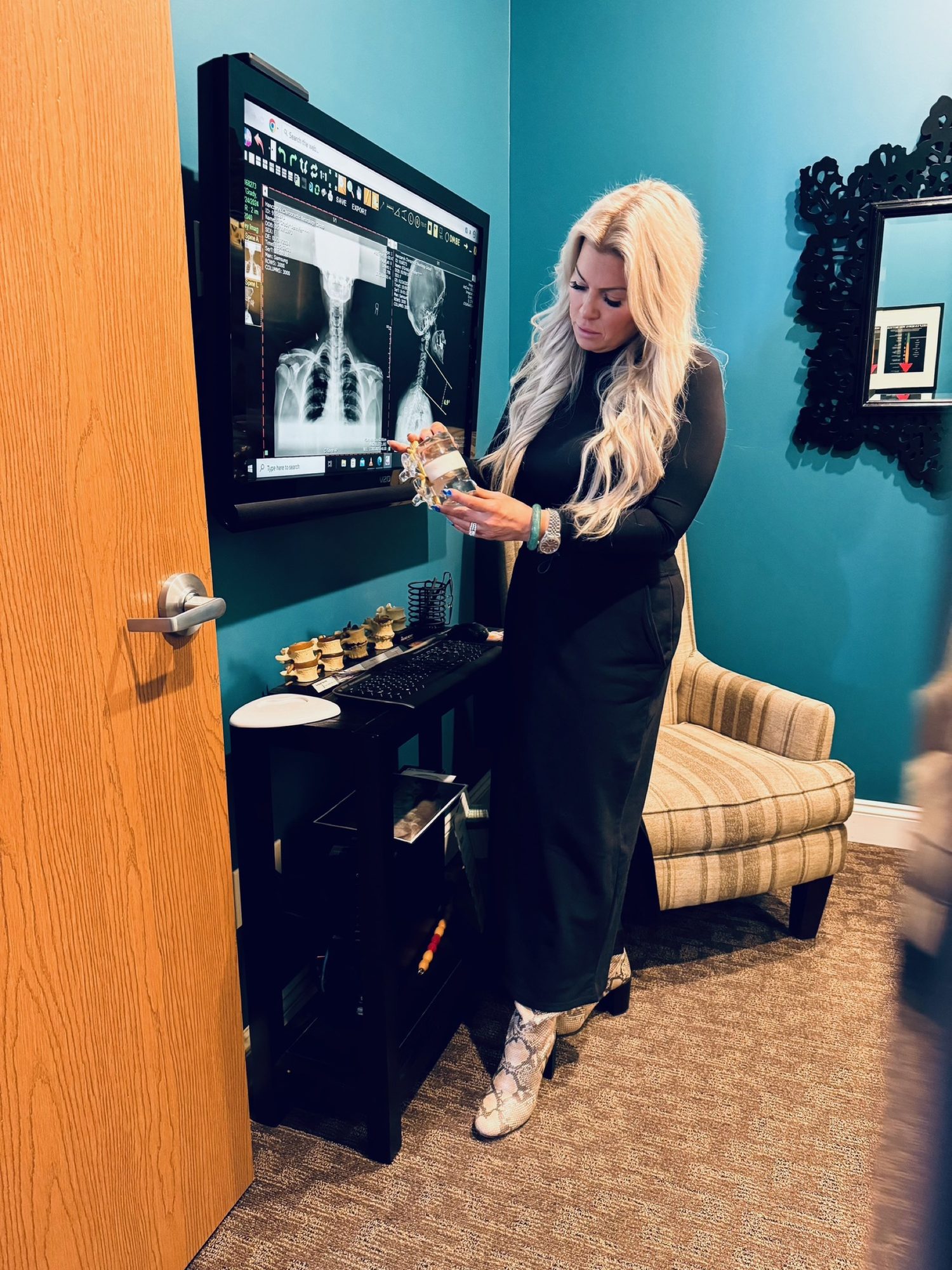 Dr. Christine reading a digital x-ray on the wall screen