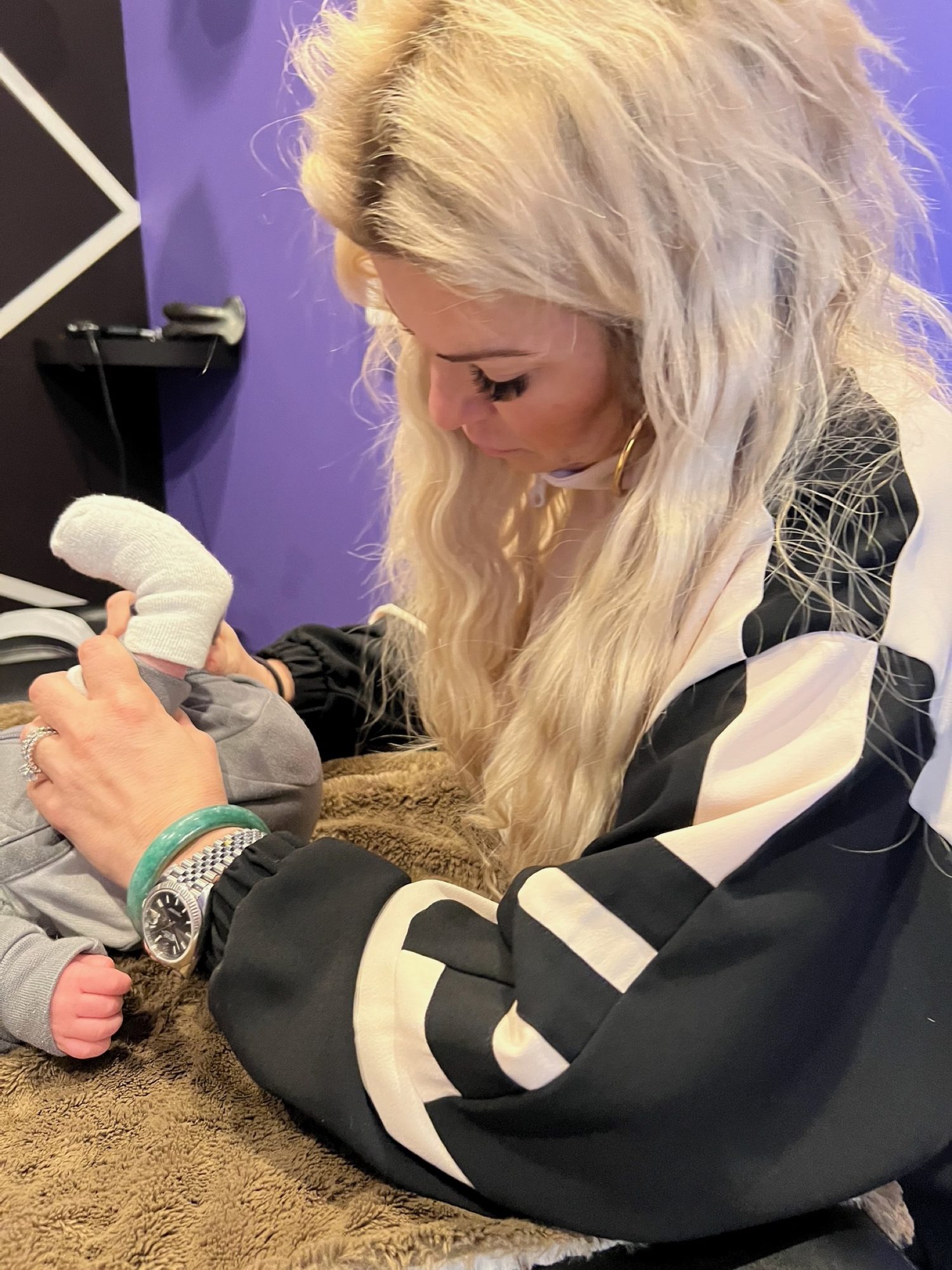 Dr. Christine holding a baby's feet during a gentle check